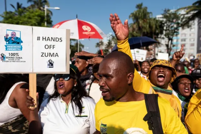 Supporters of former South Africa president Jacob Zuma demonstrate outside the High Court in Durban on April 6, 2018 where Zuma will appear for a brief preliminary hearing today on corruption charges linked to a multi-billion dollar 1990s arms deal