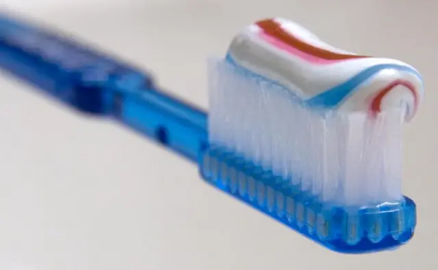 A toothbrush with toothpaste sits on a sink in Arlington, Virginia, 17 July 2007