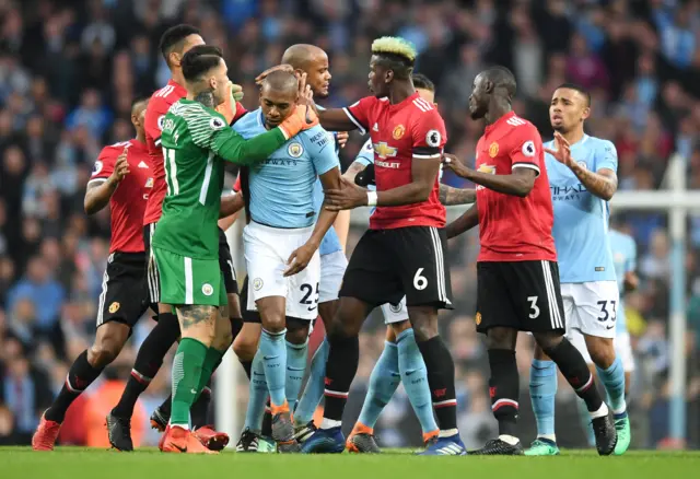 Manchester United and Manchester City players clash