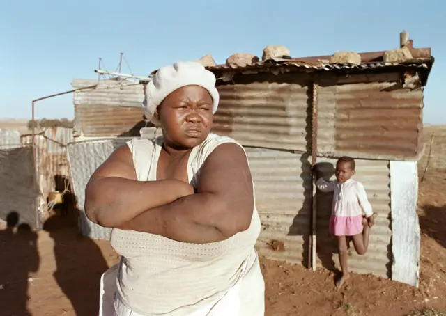 Joyce Mananki, mother of murdered child activist Stompie Moeketsi Seipei stands in front of her tin shack, 18 September 1990 at Tumahole township south of Johannesburg.