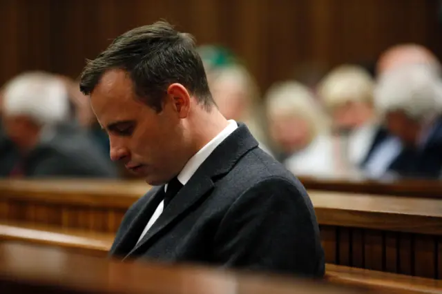 Paralympian athlete Oscar Pistorius (L), accused of the murder of his girlfriend Reeva Steenkamp three years ago, looks on during the hearing in his murder trail at the High Court in Pretoria, on July 6, 2016