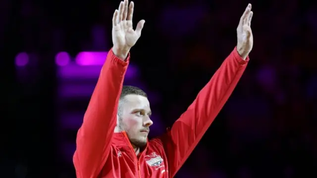 Dominick Cunningham of England celebrates winning the bronze.