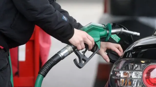 Person using petrol pump