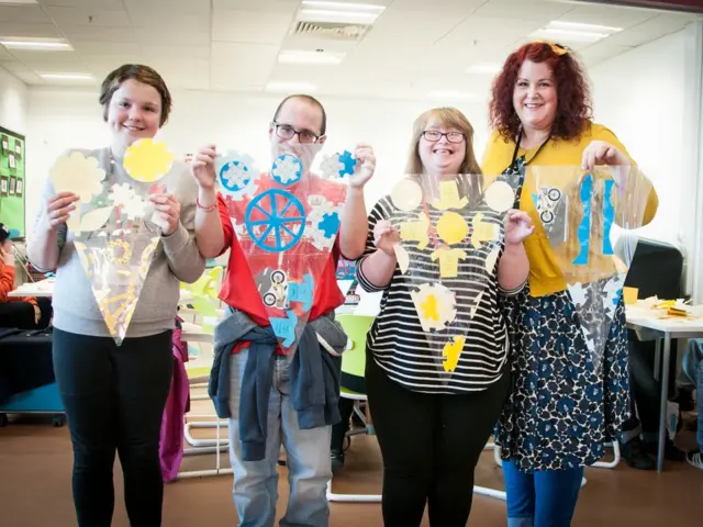 Students create blue and yellow bunting