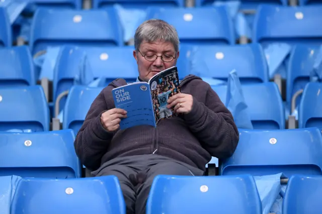 Football fan with programme