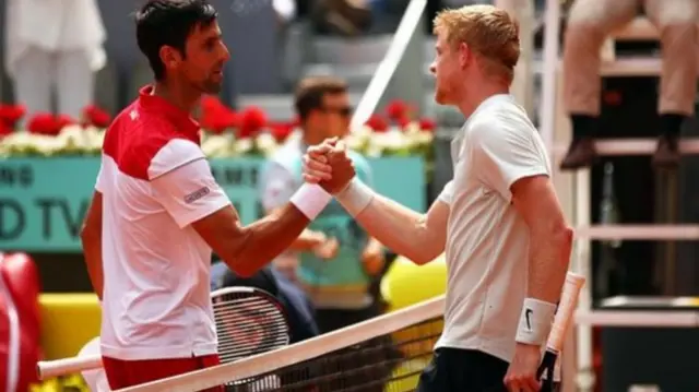 Kyle Edmund shakes hands with Novak Djokovic