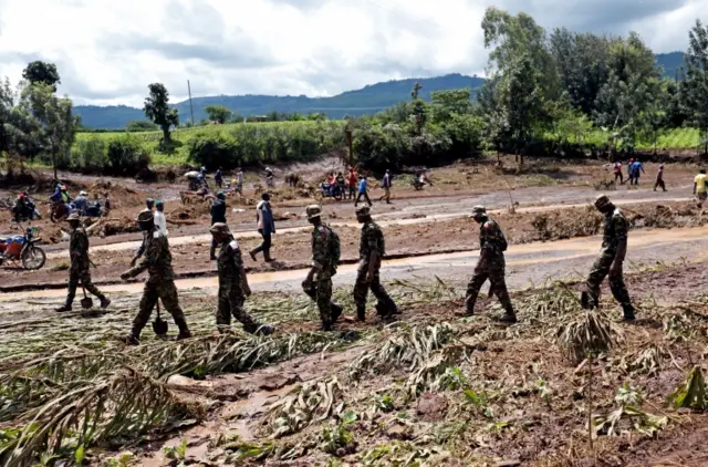 Military men and volunteers arrive for a recovery mission after a dam burst, which unleashed water at nearby homes, in Solio town near Nakuru, Kenya May 10