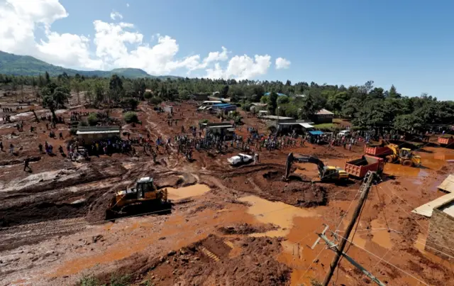 An aerial view of rescue efforts near destroyed houses by flooding water after a dam burst, in Solio town near Nakuru, Kenya May 10