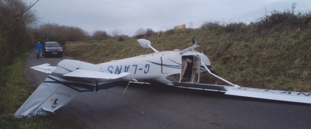 Overturned light aircraft on a rural road