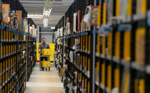 Man walks through Amazon warehouse