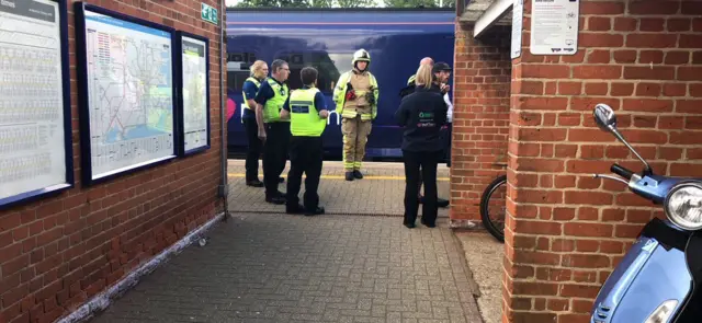 Fire fighter and police on station platform