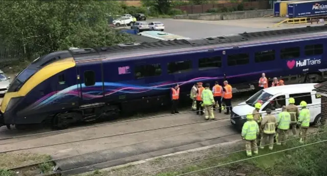 The train stopped in sidings with fife fighters  and engineers on the scene.