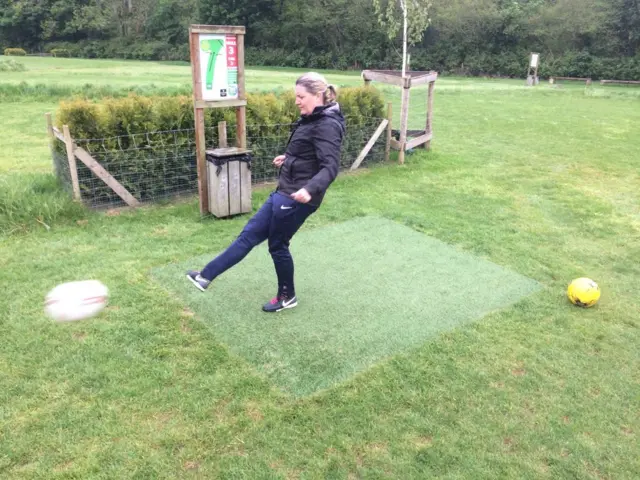 woman kicking a football