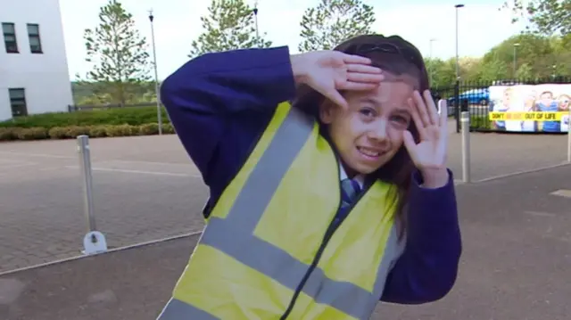 A cardboard cut out, outside the school