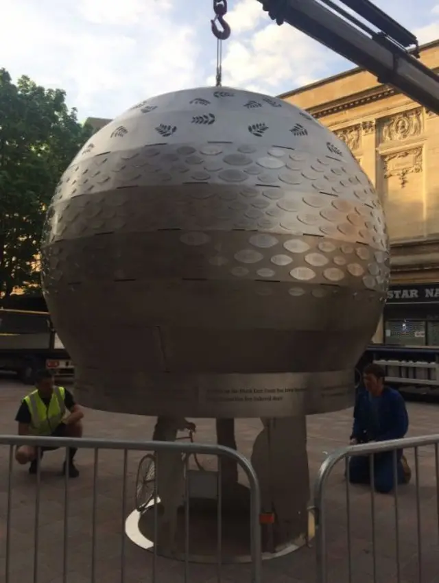 The circular memorial being lowered into place.