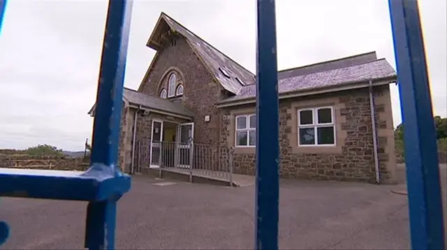 School building behind fence