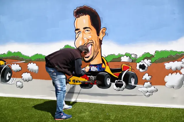 A painter designs a Daniel Ricciardo mural