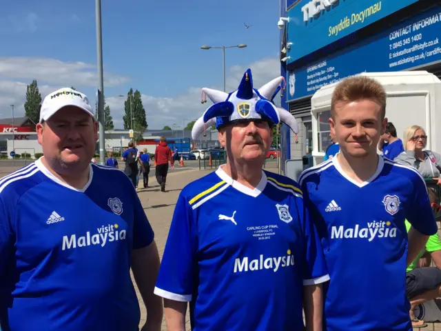 three fans outside Cardiff City Stadium