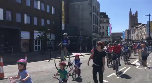 Children cycling along a Cardiff city centre road on car-free day 2018