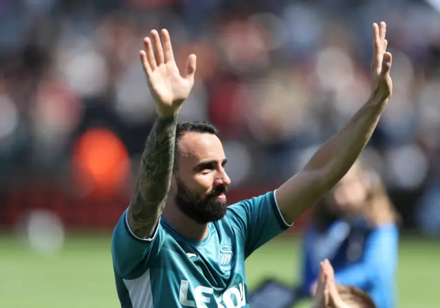 Swansea City's Leon Britton waves to the fans