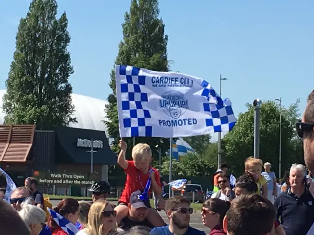 Child waving Cardiff City promotion flag