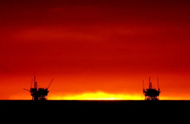 Oil rigs at sunset