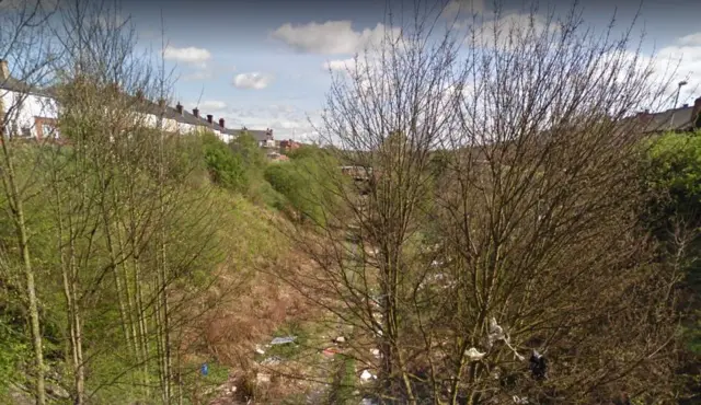 Litter on disused railway embankment