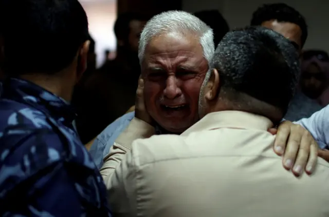 A relative of Palestinian Ahmed al-Rantisi, who was killed during a protest at the Israel-Gaza border, is consoled at a hospital in the northern Gaza Strip May 14, 2018.