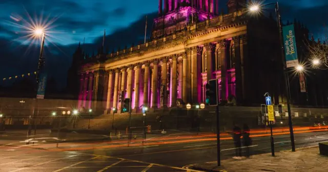 Leeds Town Hall lit up in pink