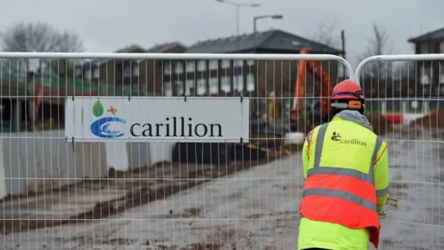 Worker by Carillion sign