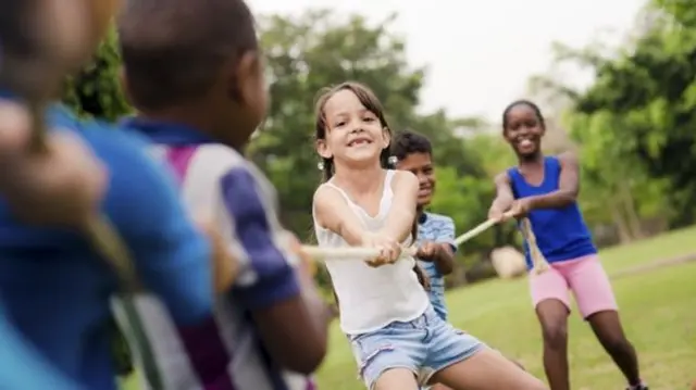 Chlidren play tug of war