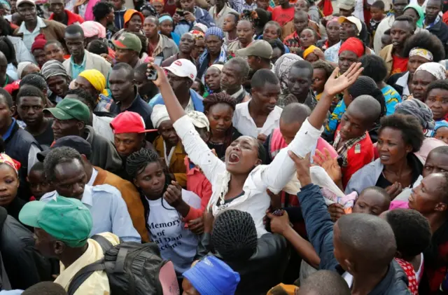 A mourner reacts as they prepare to bury their relative killed when a dam burst its walls, overrunning nearby homes, in Solai town near Nakuru, Kenya May 16, 2018.