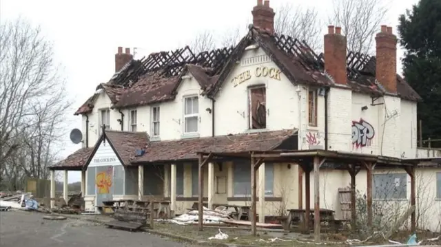 The burnt out Cock Inn