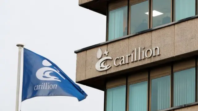 Workers at Carillion stand in an office after the company went into liquidation, in Wolverhampton