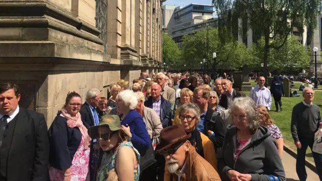 People queuing outside cathedral