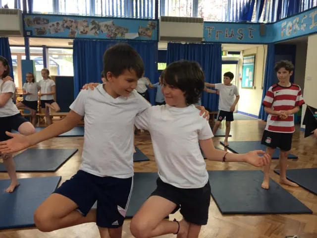 two children doing yoga