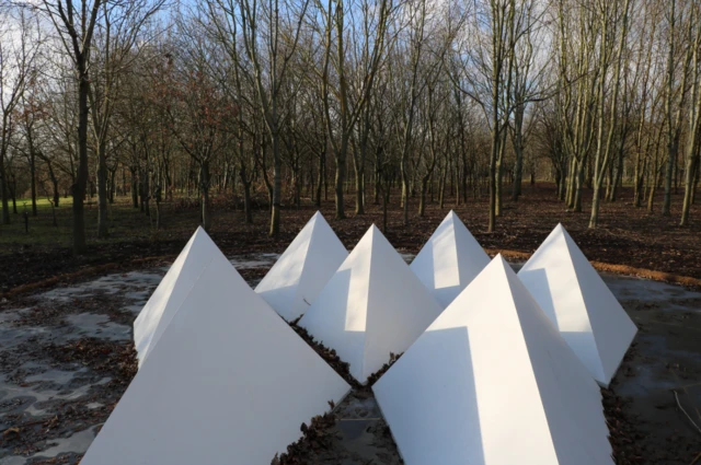 pyramid-shaped memorial with trees behind