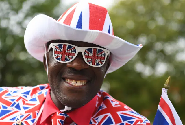 Joseph Afrane wearing a union flag hat, jacket and tie