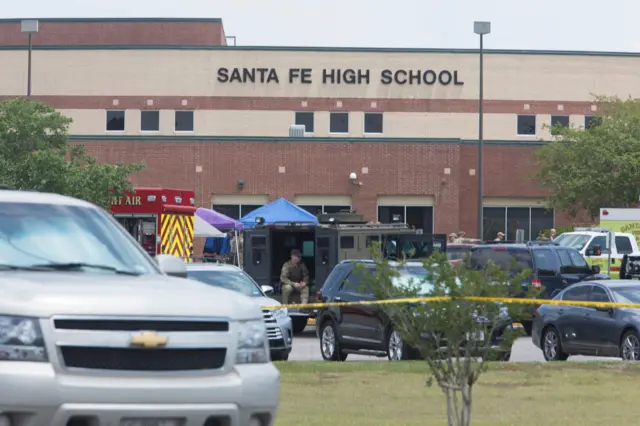 Emergency crews gather in the parking lot of Santa Fe High School