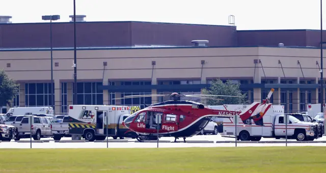 Emergency crews stage in the parking lot of Santa Fe High School