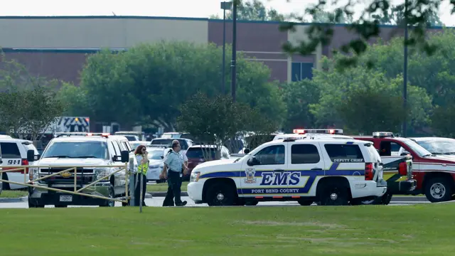 Emergency medical personnel stage in the Santa Fe High School parking lot