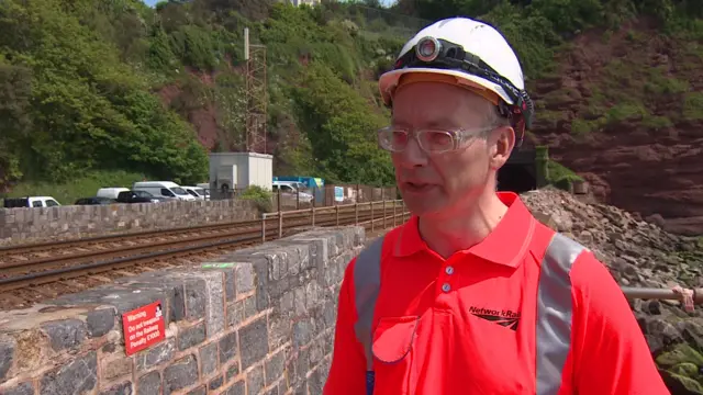 worker next to railway