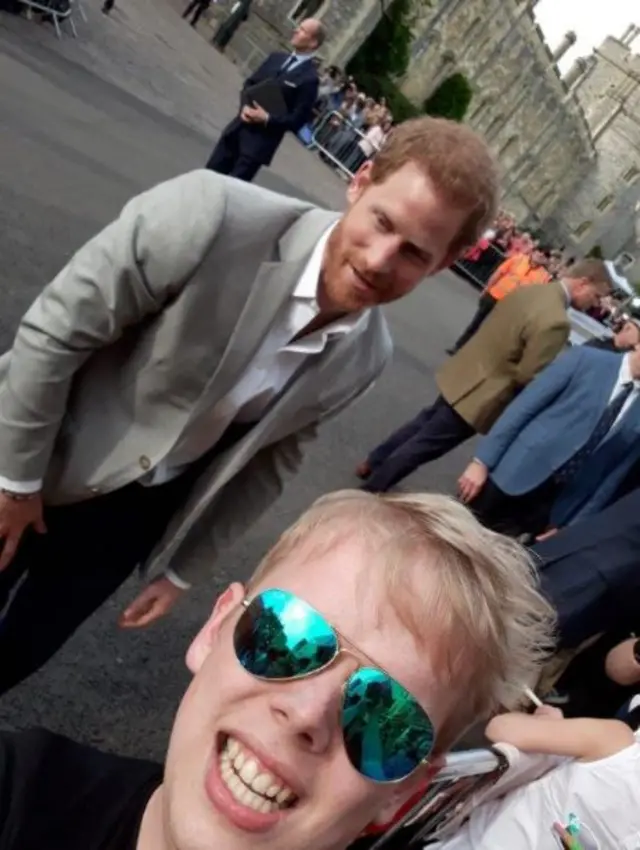 A fan takes a selfie with Prince Harry