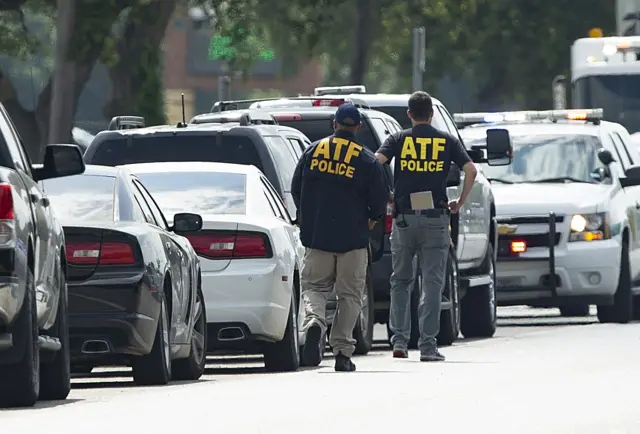 Emergency medical personnel stage in the Santa Fe High School parking lot