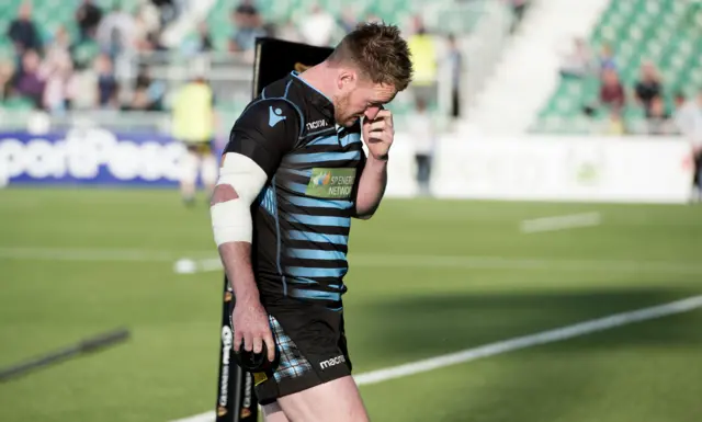 Stuart Hogg walks off the pitch, unable to take part in tonight's game