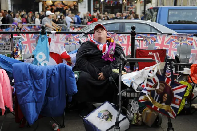 A man prepares to bed down for the night at Windsor