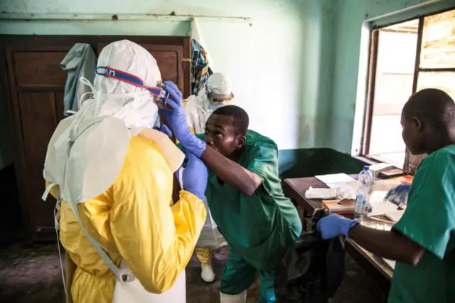 health workers wear protective equipment as they prepare to attend to suspected Ebola patients at Bikoro Hospital - the epicenter of the latest Ebola outbreak in the Democratic Republic of Congo