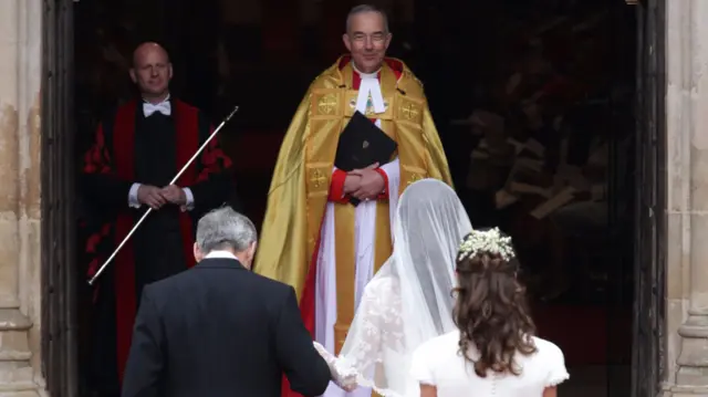 John Hall at the door to the Abbey as Kate and her family arrive