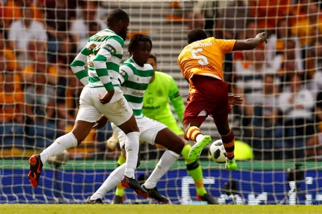 Motherwell"s Gael Bigirimana sees his shot deflected wide by Celtic's Dedryck Boyata