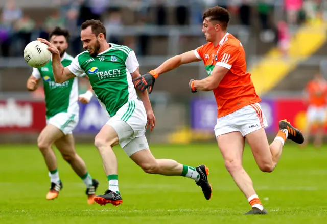 Fermanagh's Paul McCusker gets a tug from Connaire Mackin in the Brewster Park encounter